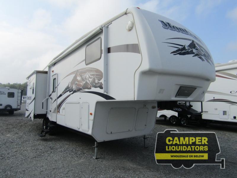 Used 2009 Keystone RV Montana 3075RL fifth wheel parked outside on the dealer lot