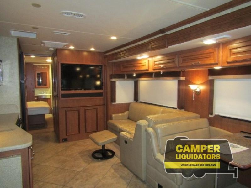 Used 2013 Fleetwood RV Southwind 36L interior of the motorhome with wooded trim, entertainment center, seating, and more